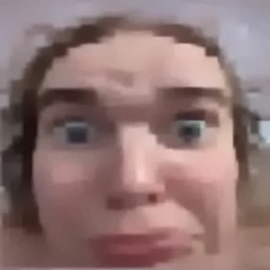 extremely low quality image of june's face in a shocked expression